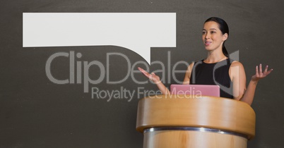 Business woman with speech bubble talking against grey background