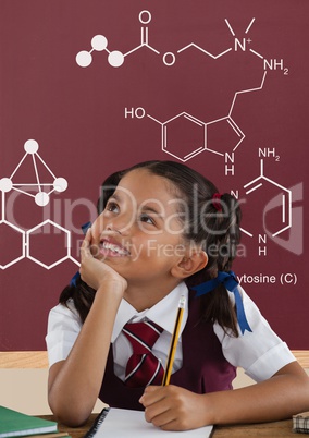 Student girl at table looking up against red blackboard with school and education graphic
