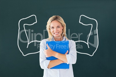Happy student woman with fists graphic standing against green blackboard