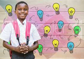 Schoolboy in front of colorful light bulbs on wood