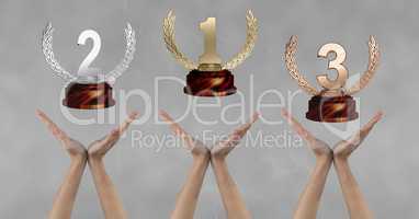 Women with trophies on hands