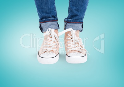 Beige shoes on feet with blue background