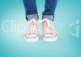 Beige shoes on feet with blue background