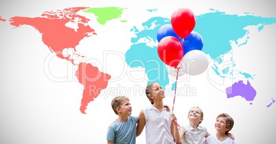 Kids holding balloons in front of colorful world map