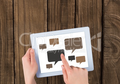 Chat icons on tablet with hands