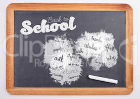 school subjects and back to school text on blackboard
