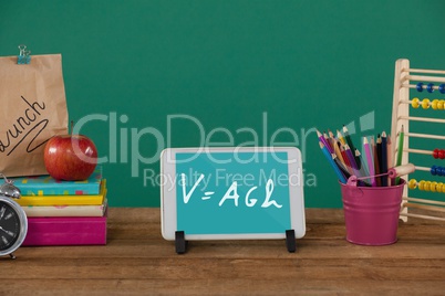 Tablet on a school table with school icons on screen