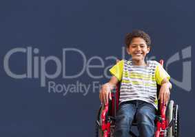 Disabled boy in wheelchair in front of blackboard