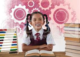 Schoolgirl reading at desk in front of settings gear cogs