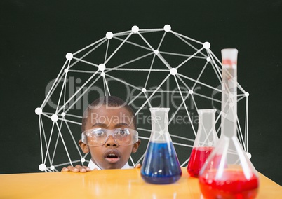 Surprised student boy at table against green blackboard with education graphic