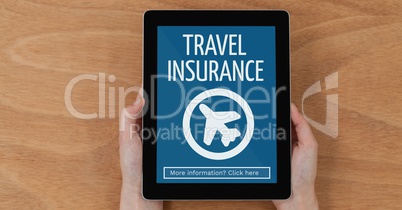 Person holding a tablet with travel insurance concept on screen