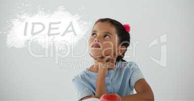 Student girl at table looking up against white blackboard with idea text