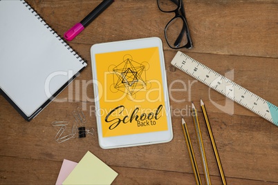 Tablet on a school table with school icons on screen