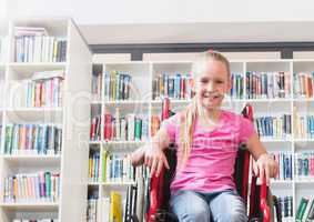 Disabled girl in wheelchair in school library