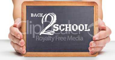 Back 2 school written on blackboard in hands