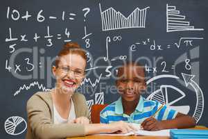Student boy and teacher at table against blue blackboard with education and school graphics