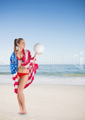 Woman holding a USA flag in the beach