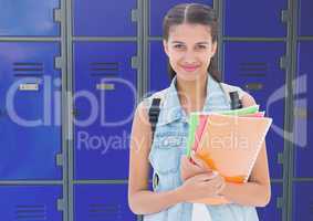 female student holding files in front of lockers