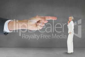 Hand pointing at business woman against grey background