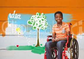 Disabled boy in wheelchair with idea colorful drawings