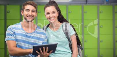 Composite image of students using tablet and smiling