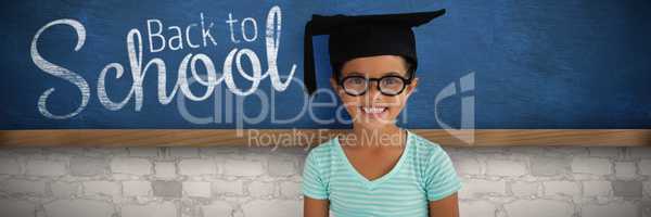 Composite image of portrait of cheerful girl wearing eyeglasses and mortarboard