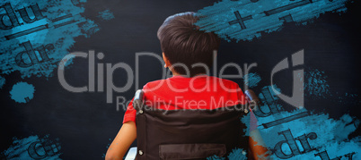 Composite image of rear view of boy sitting in wheelchair