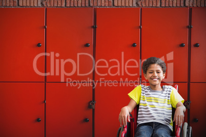 Composite image of cute disabled pupil smiling at camera in hall