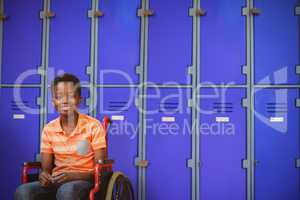 Composite image of full length portrait of happy boy on wheelchair