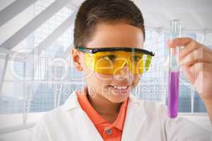 Composite image of schoolboy looking at test tube