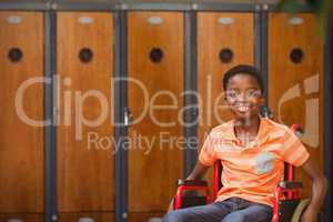 Composite image of portrait of boy sitting in wheelchair at library