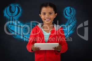 Composite image of portrait of smiling girl holding digital tablet