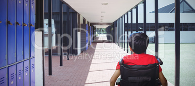 Composite image of rear view of boy sitting in wheelchair