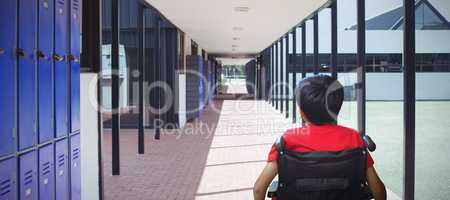 Composite image of rear view of boy sitting in wheelchair