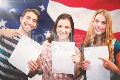 Composite image of smiling students showing their exams