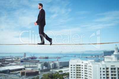 Composite image of handsome businessman in suit walking away