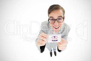 Composite image of geeky hipster smiling and showing card