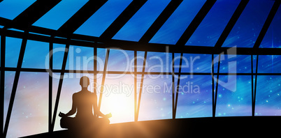 Composite image of silhouette woman doing meditation