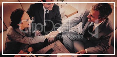 Business people shaking hands while working