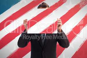 Composite image of businessman holding a white card in front of his face