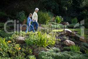 Grandmother and granddaughter walking in the garden