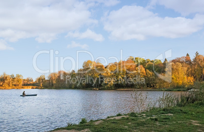 The autumn wood on the bank of the big beautiful lake