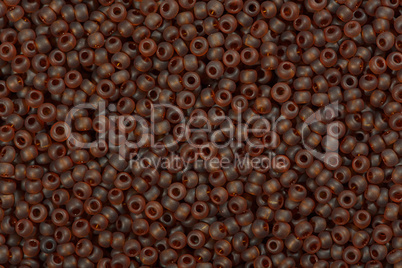 Multicolored beige seed beads background.