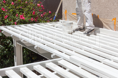 Professional Painter Rolling White Paint Onto The Top of A Home