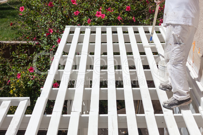 Professional Painter Rolling White Paint Onto The Top of A Home