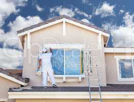Professional House Painter Painting the Trim And Shutters of A H
