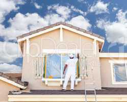 Professional House Painter Painting the Trim And Shutters of A H