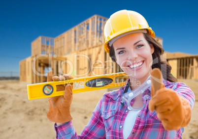 Female Construction Worker with Thumbs Up Holding Level Wearing