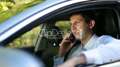 Busy businessman communicating on phone in car