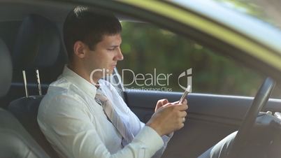 Entrepreneur surfing net on phone in car